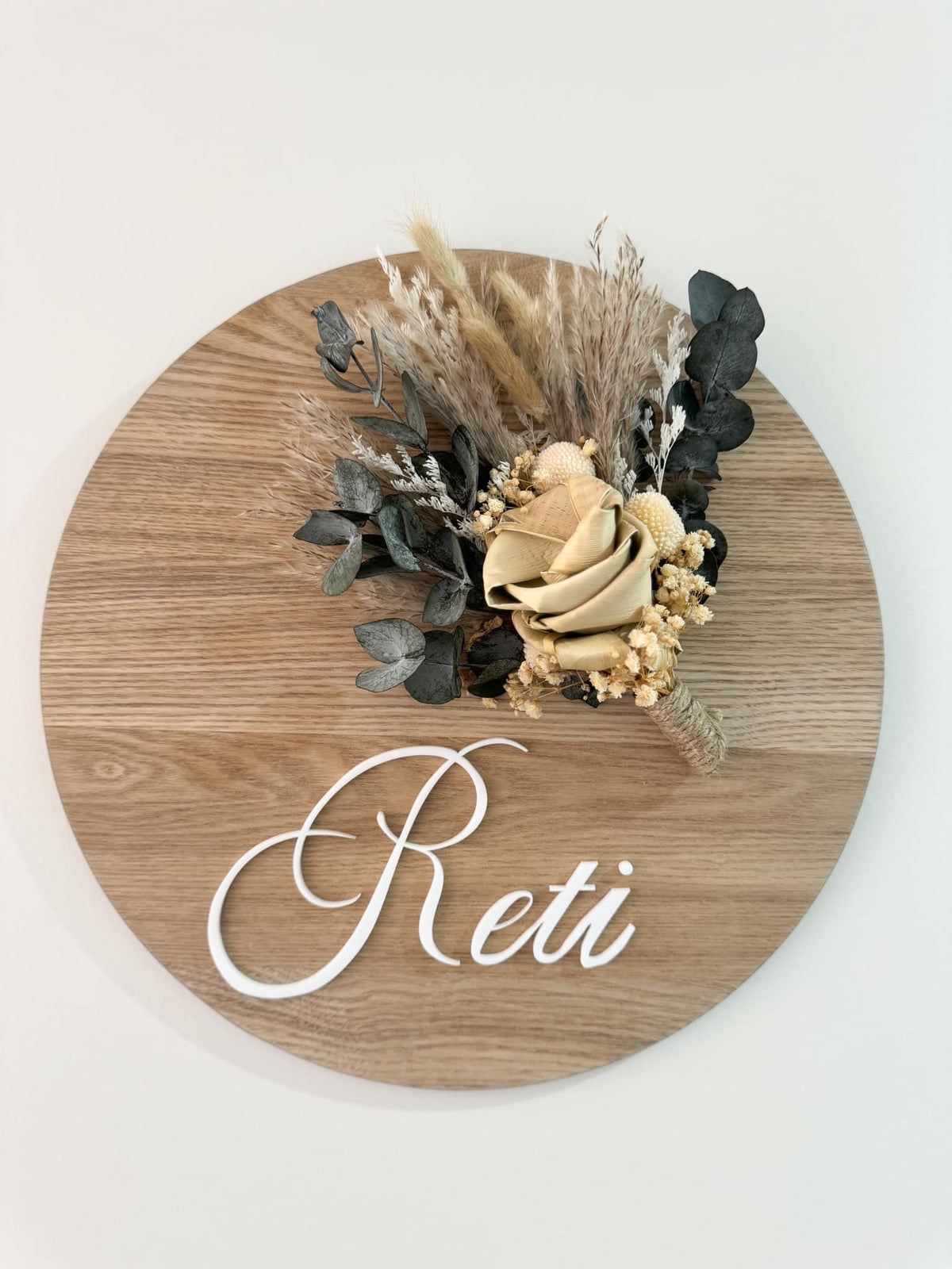Personalised wooden plaque with harakeke flowers