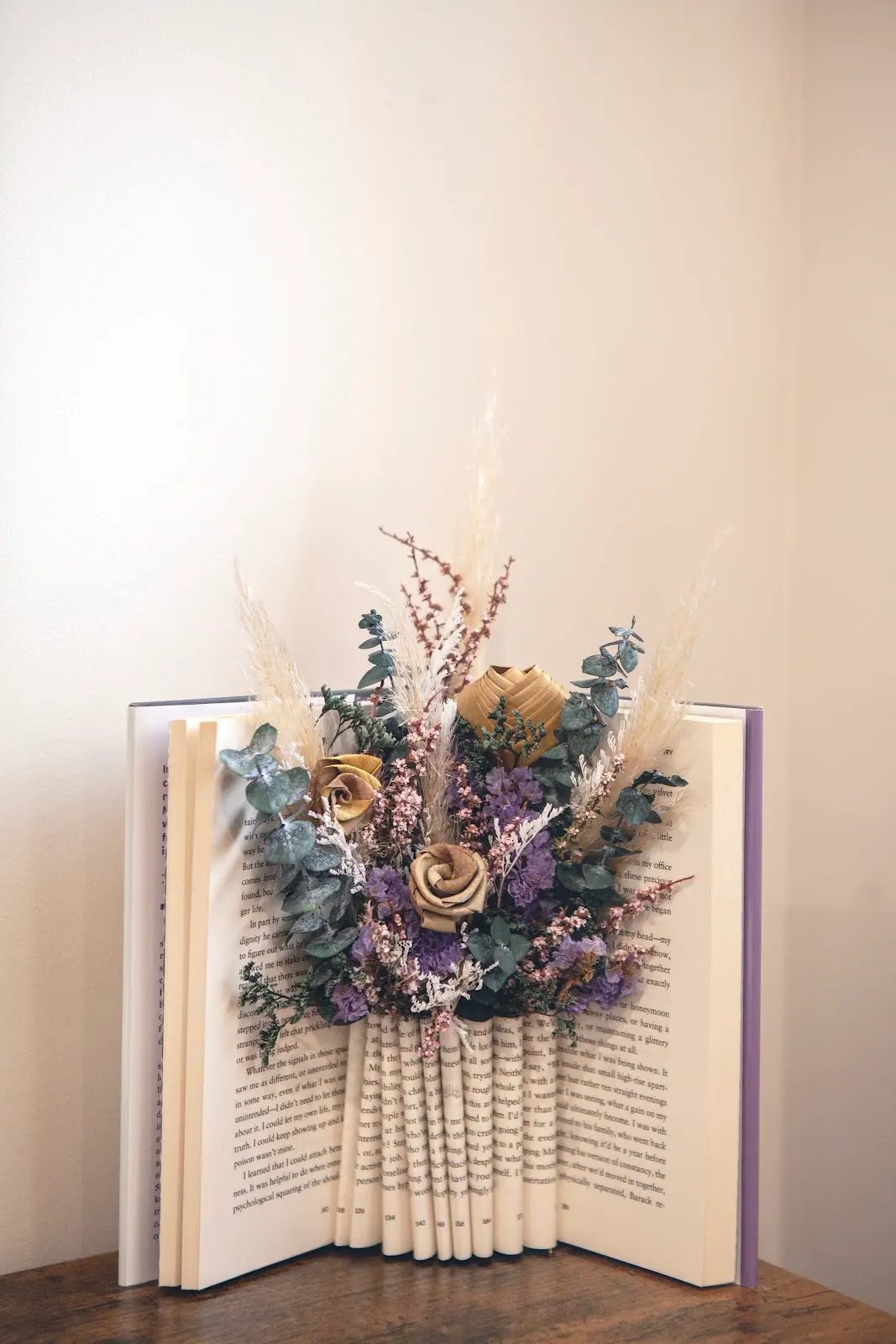Dried flowers arranged inside the pages of an open book
