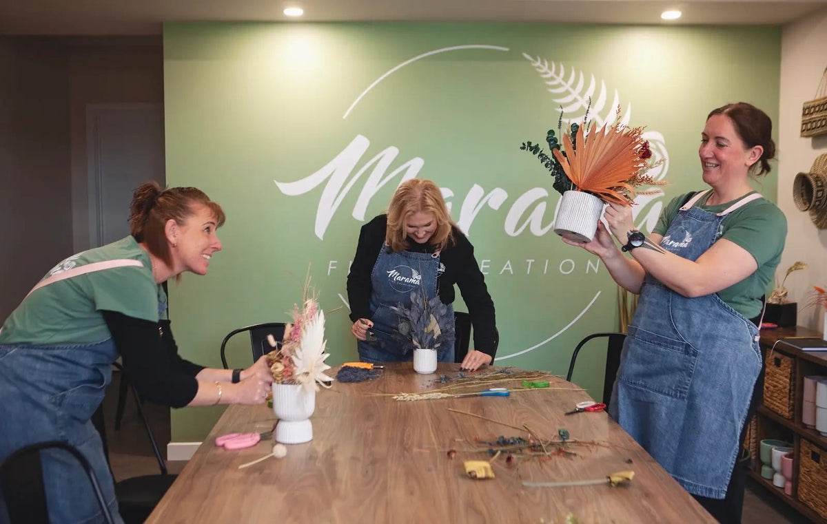 The Marama team preparing flowers at the studio table